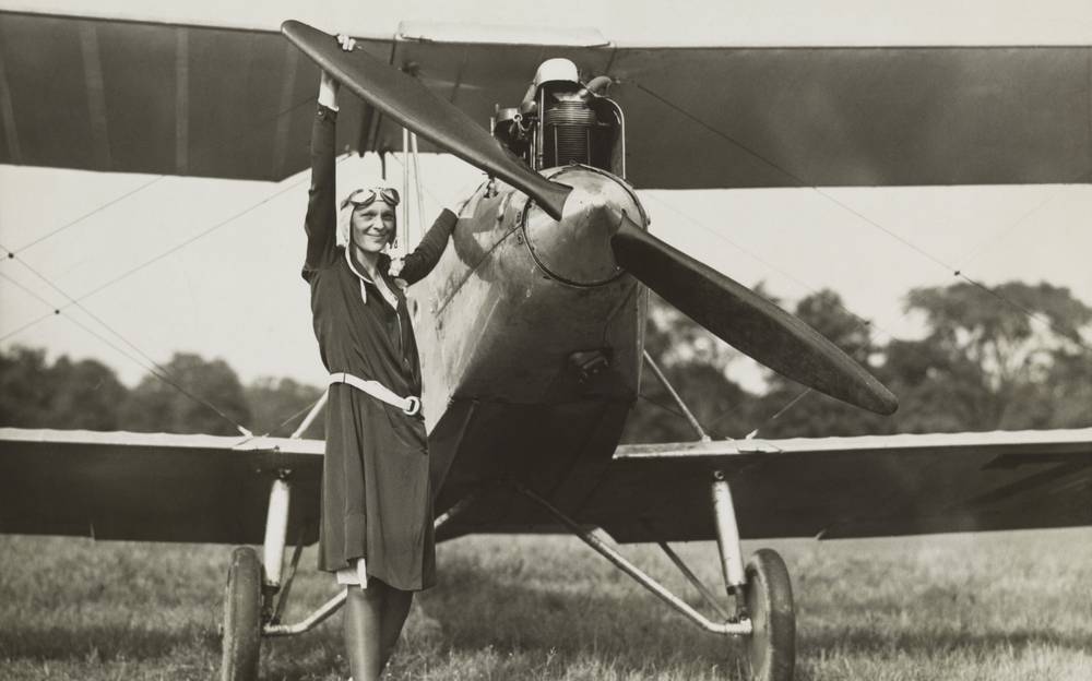 Amelia Earhart, turning the propeller off a plane