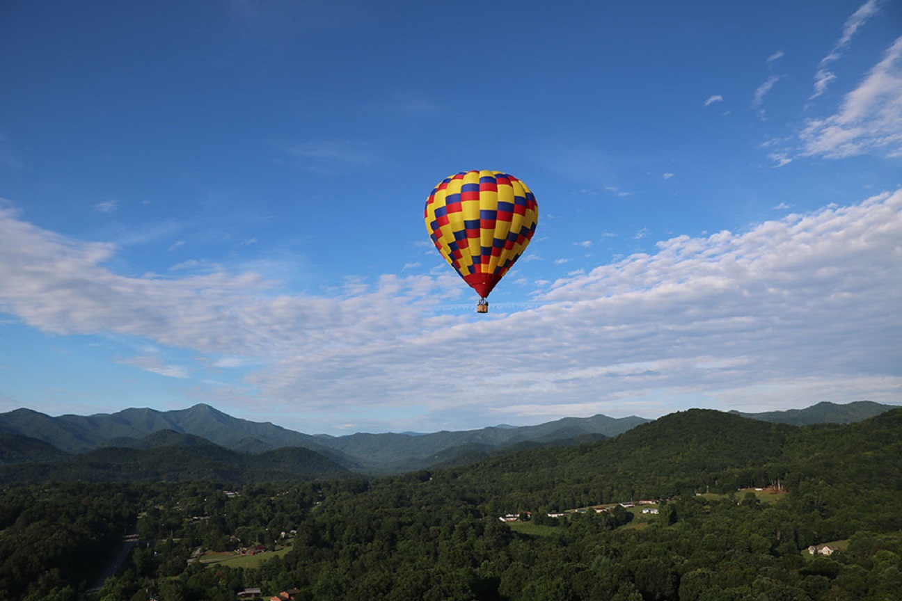 A hot air balloon flying in the Mountains