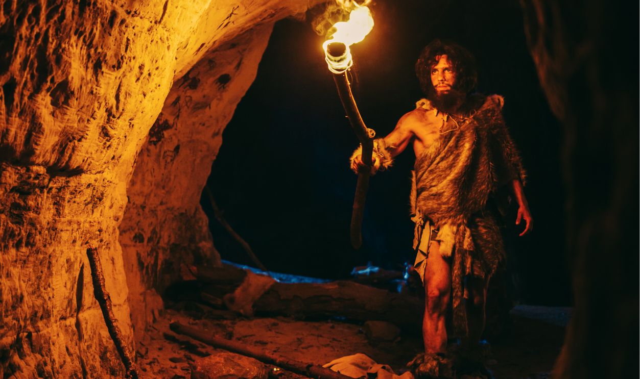 cave man with fure in hand