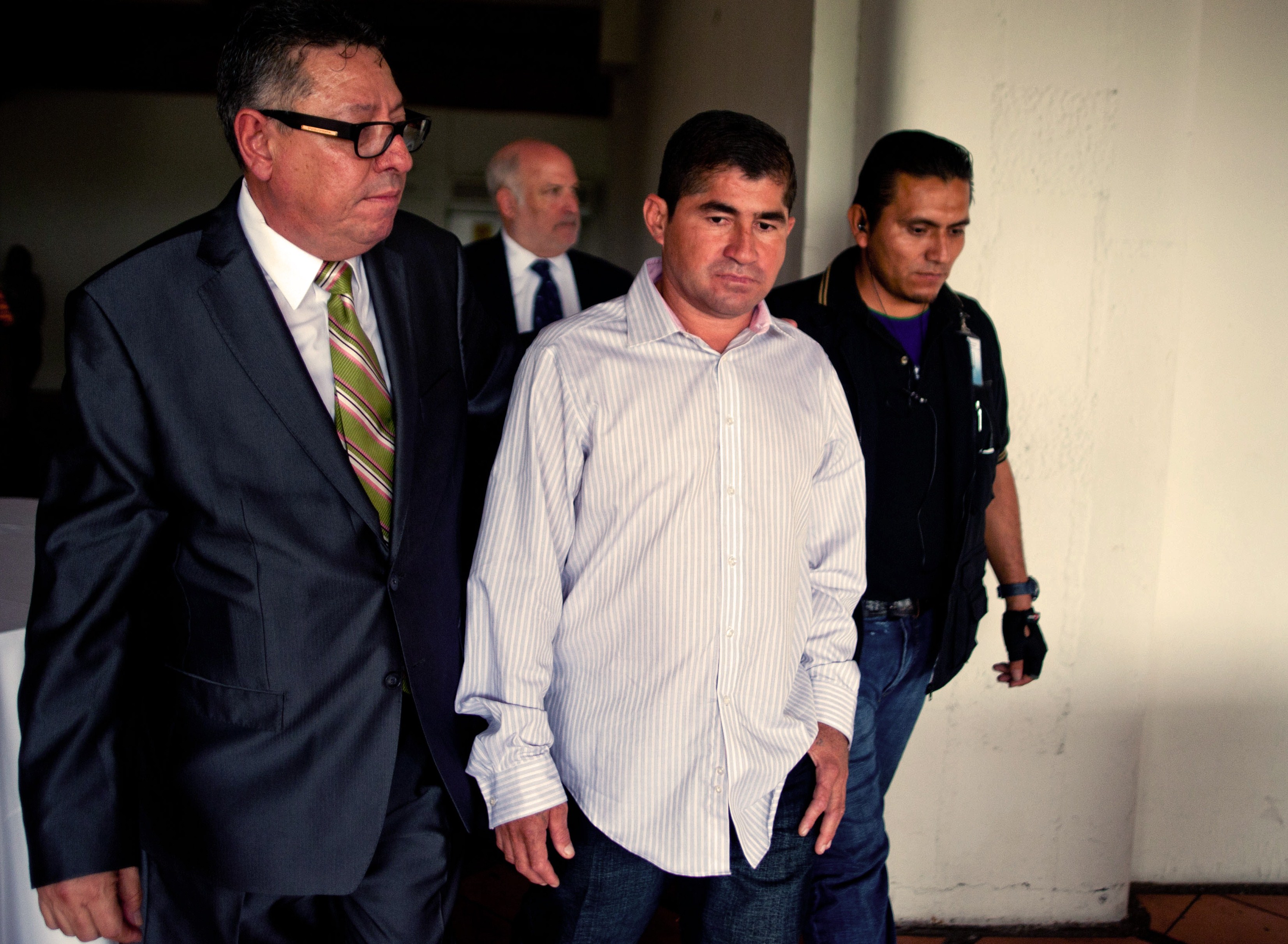Salvadorean castaway Jose Salvador Alvarenga (C) walks with representatives