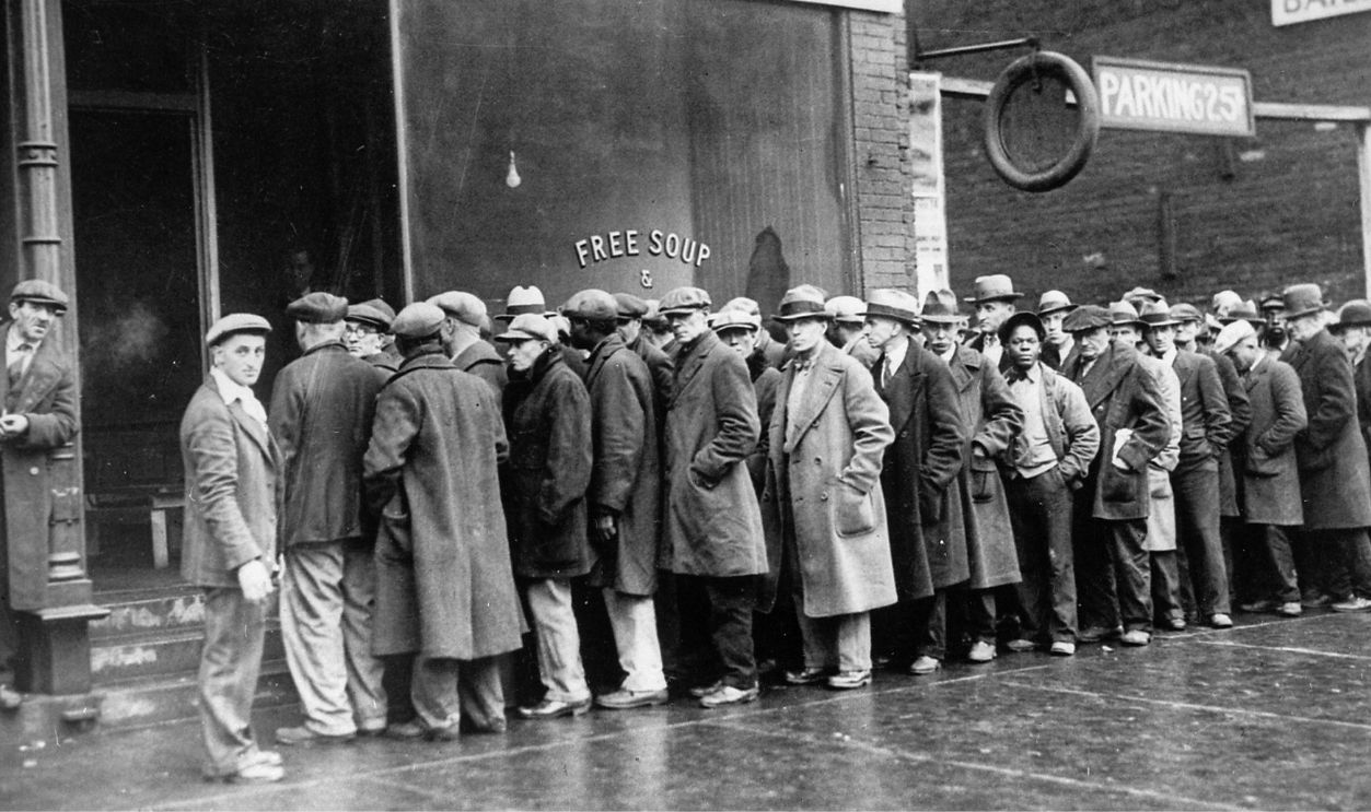 Unemployed men queued outside a depression soup kitchen 
