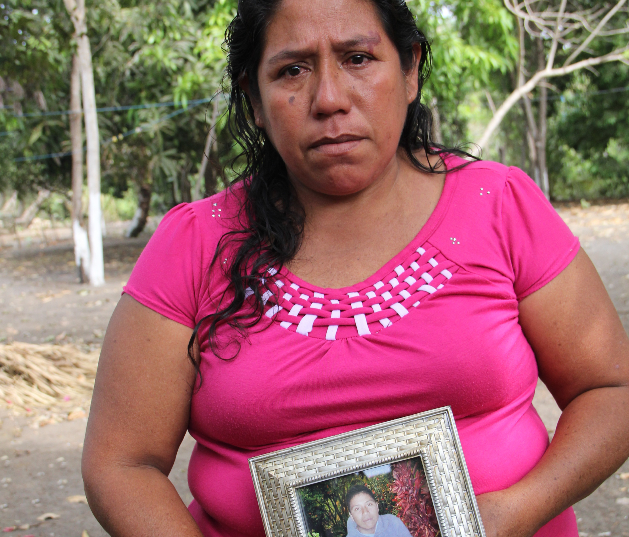 Roselia Diaz, mother of dead castaway Ezequiel Cordoba, shows his portrait
