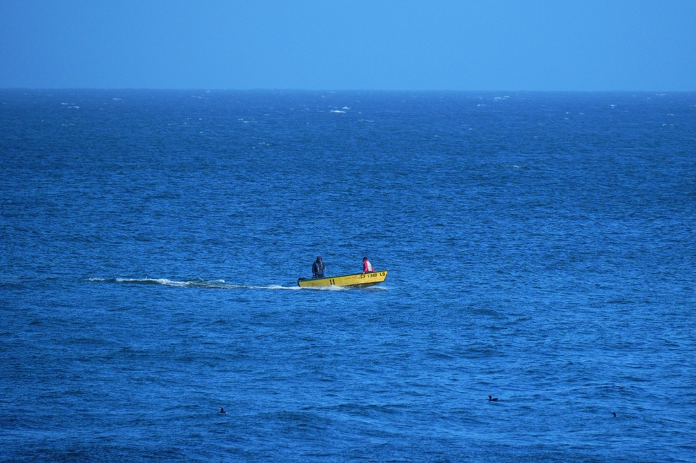 Two men in a small boat on the Monterey Bay.