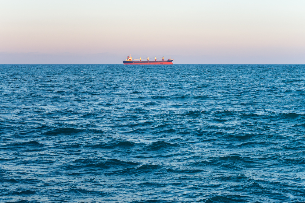 Lonely cargo ship in the distance