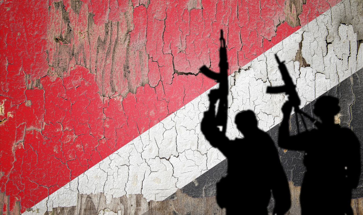Flag of Sealand painted on the cracked wall with terrorist attack shadow.