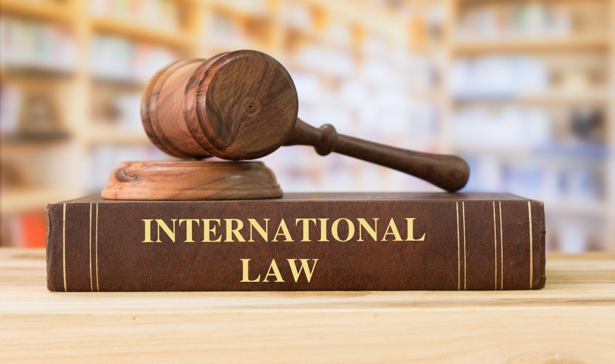 International law book with a judges gavel on desk