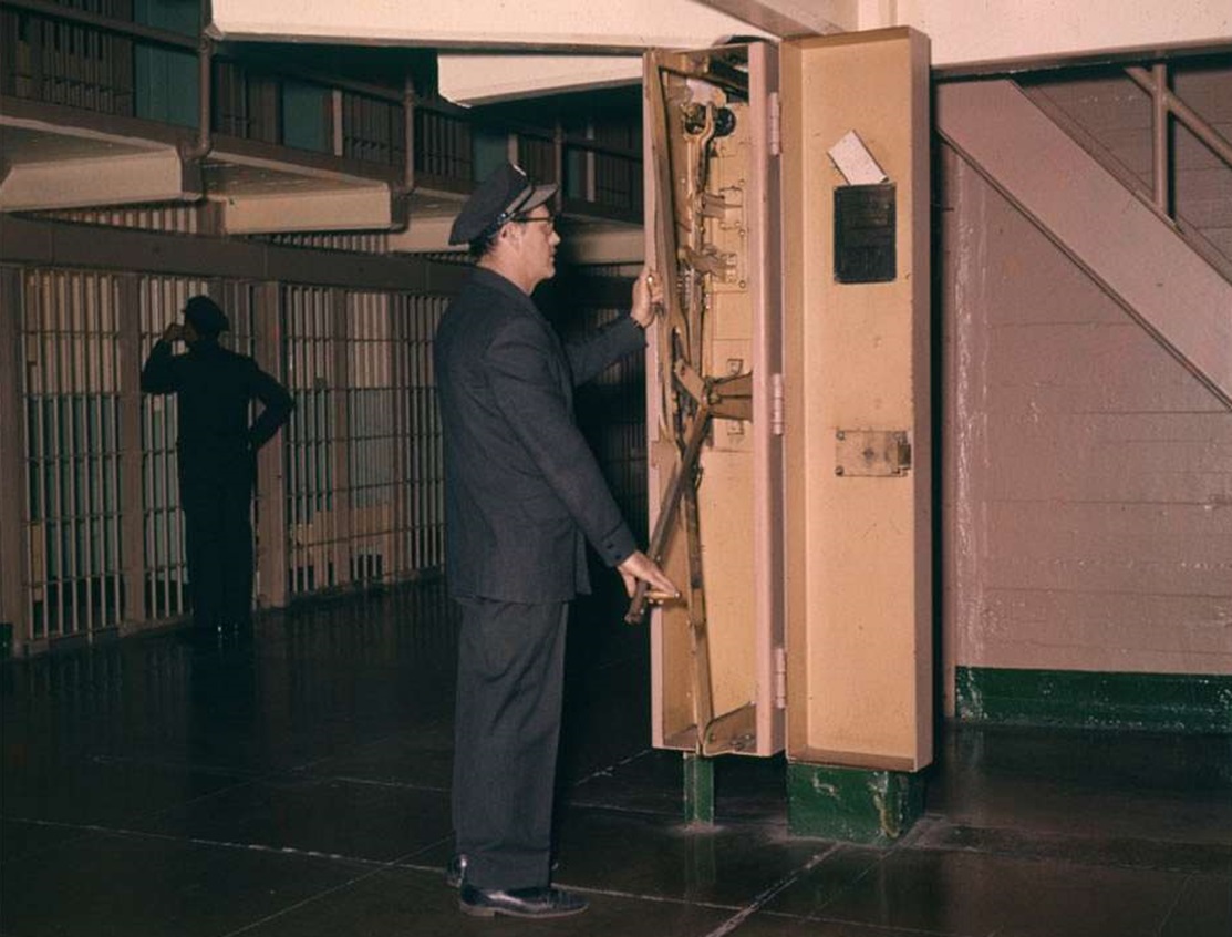 Alcatraz Correctional Officer locking the cell block doors, 1960.