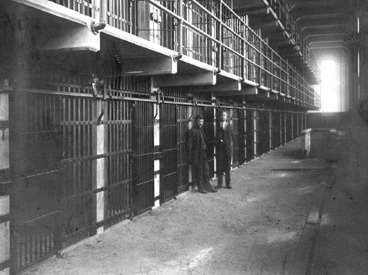 Two men standing in the newly completed Alcatraz cell block D before opening - 1911
