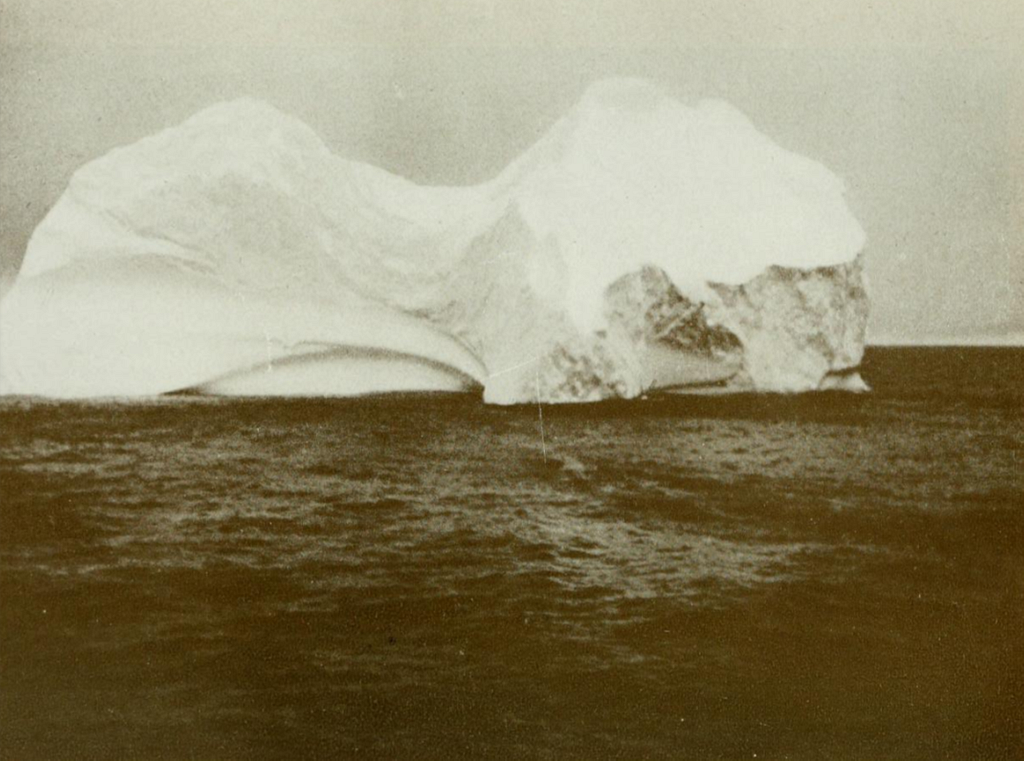 Close Up Grayscale Photo of Iceberg floating in the sea