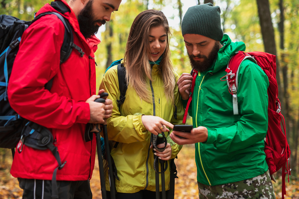 Men and woman checking phone