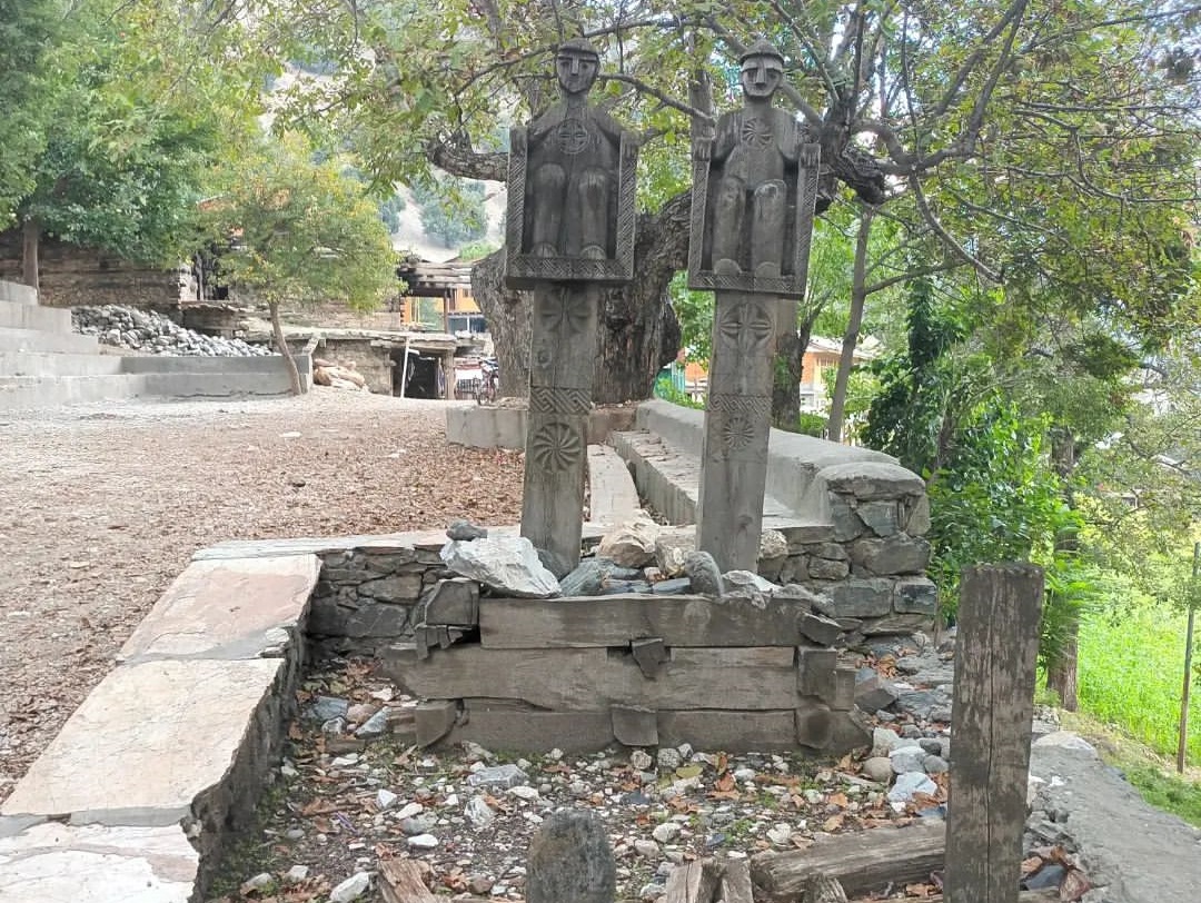 Kalasha Wooden Statues at graveyard.