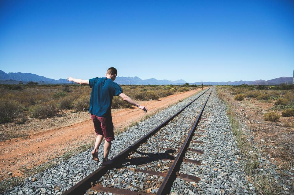 Man Standing on Train Tracks