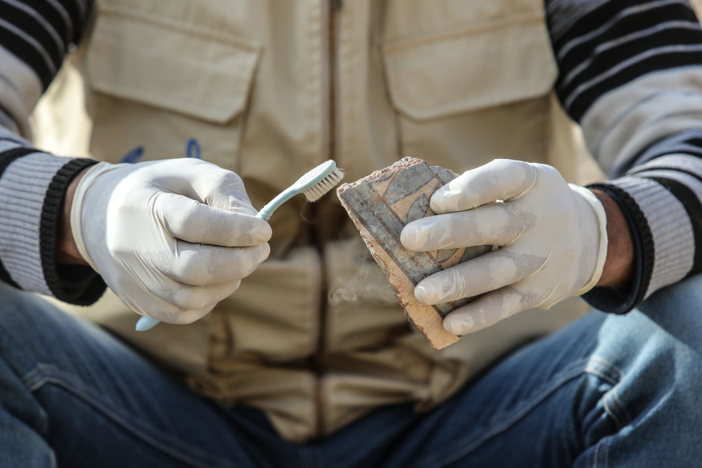 Archaeologists work to restore pottery shards and artifacts unearthed at Queen Hatshepsut's temple in Luxor