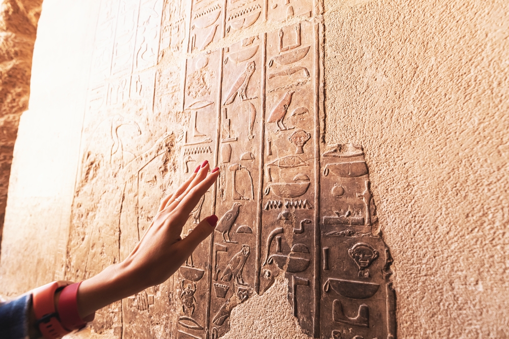 An Egyptologist or archaeologist reads and translates Egyptian hieroglyphs
