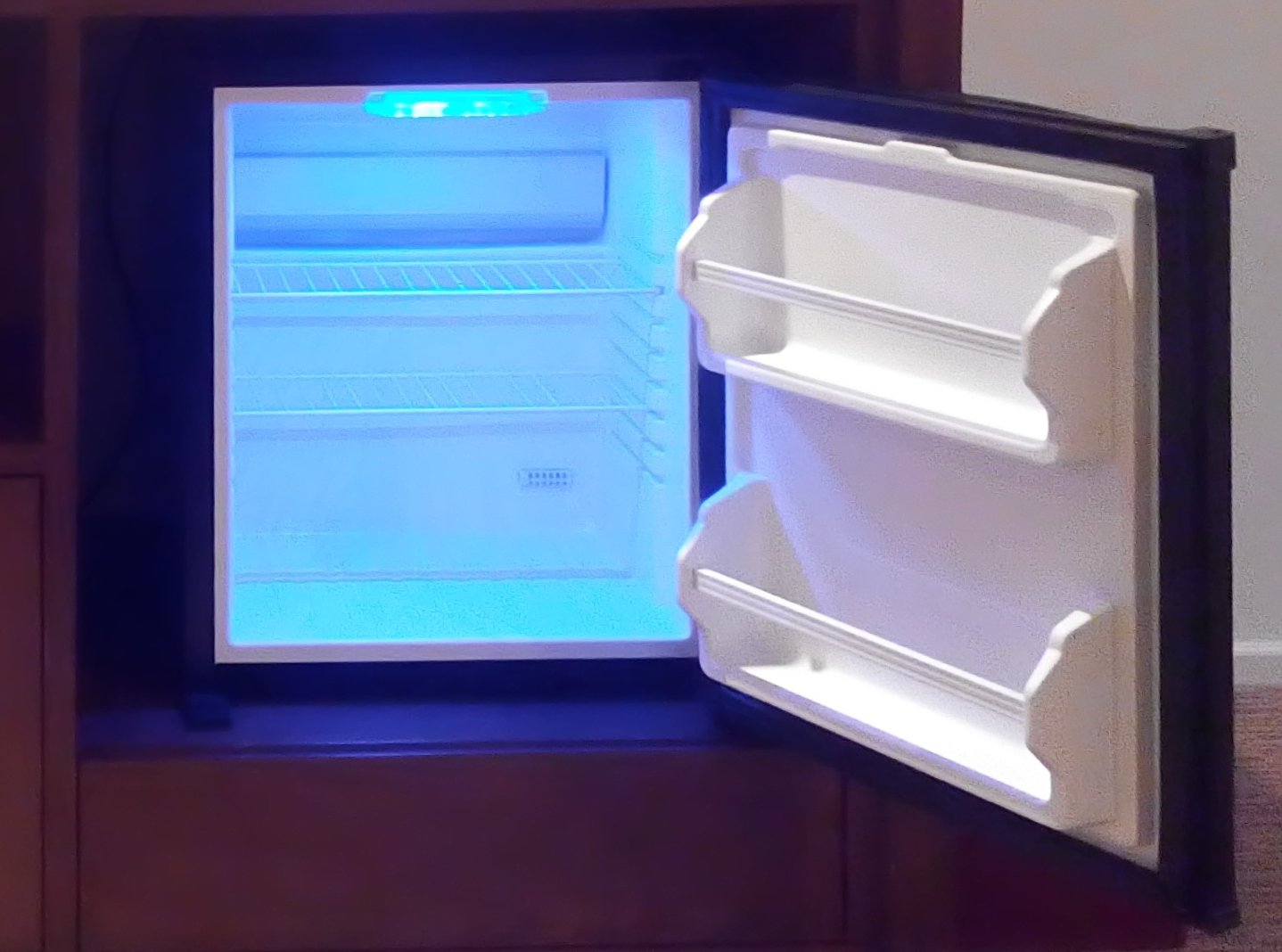 This image shows a Minibar refrigerator with its door open