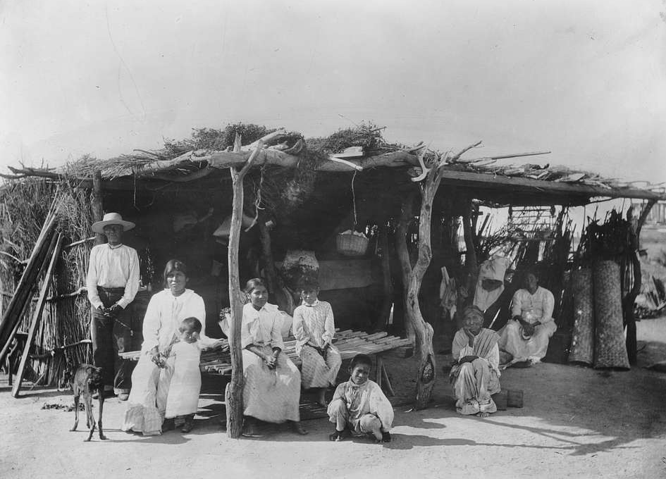 A group of 8 Yaqui Indians at their dwelling, Mexico, ca.1910
