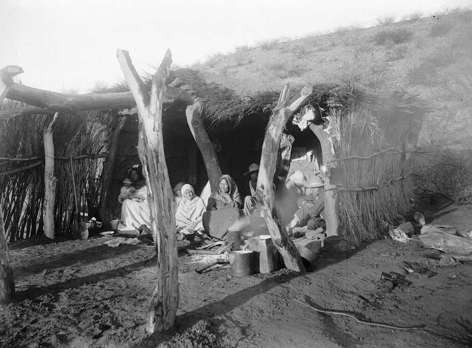A family of escaped Yaqui Indians under a shelter in Arizona, ca.1910
