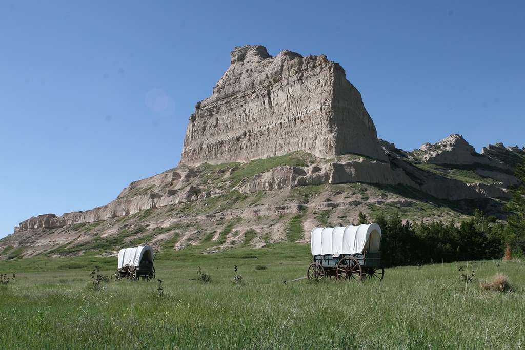 Two replica covered wagons sit at the base of Eagle Rock