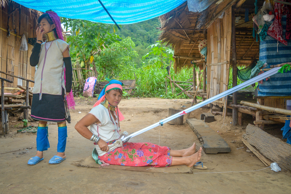Long Neck Karen hill-tribe (Long Neck) elder weaving fabrics for a living at her house.