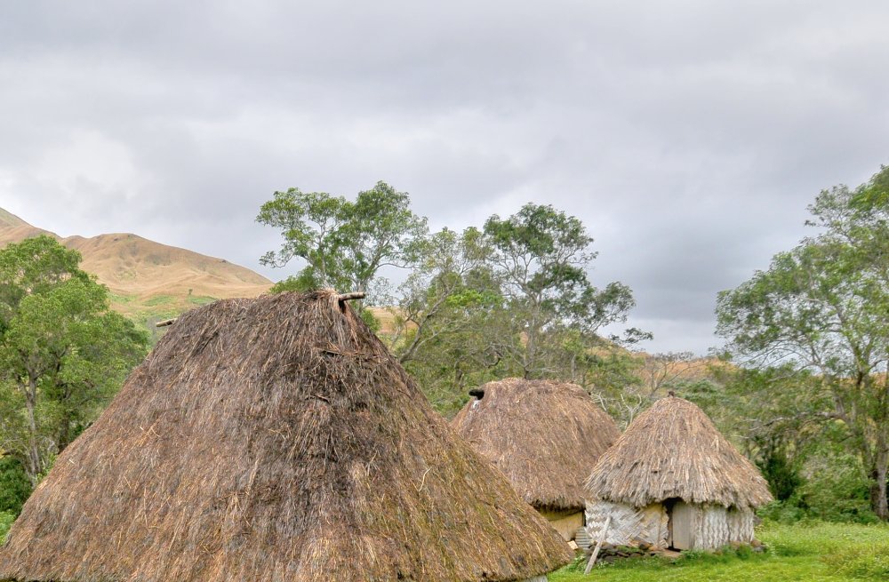Landscape Photo of the Navala village on Fiji, Cloudy Sky in the Background