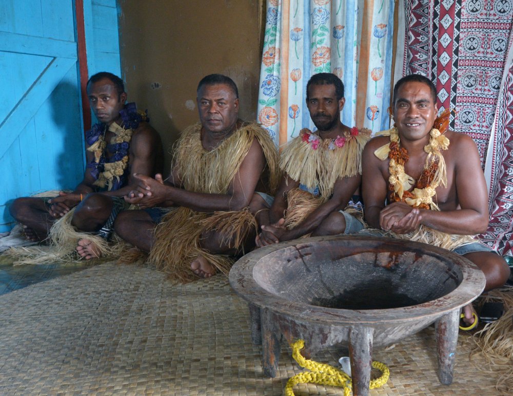 Indigenous Fijians men participate in traditional Kava Ceremony