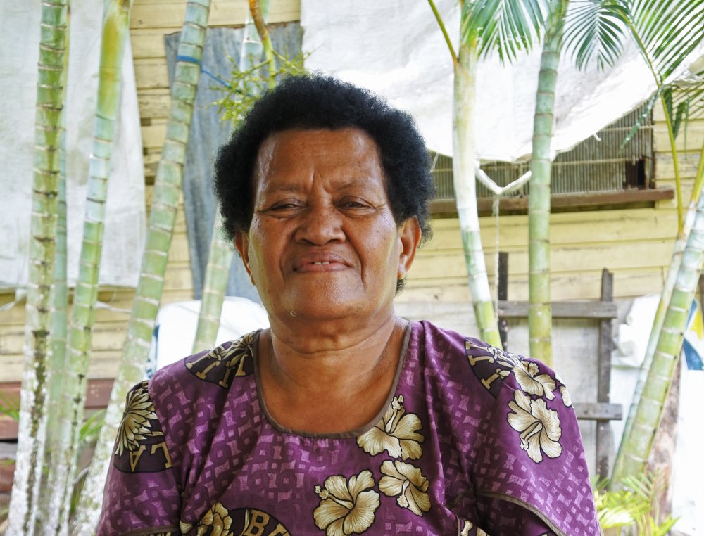 Portrait Photo of Elderly indigenous Fijian woman in purple dress