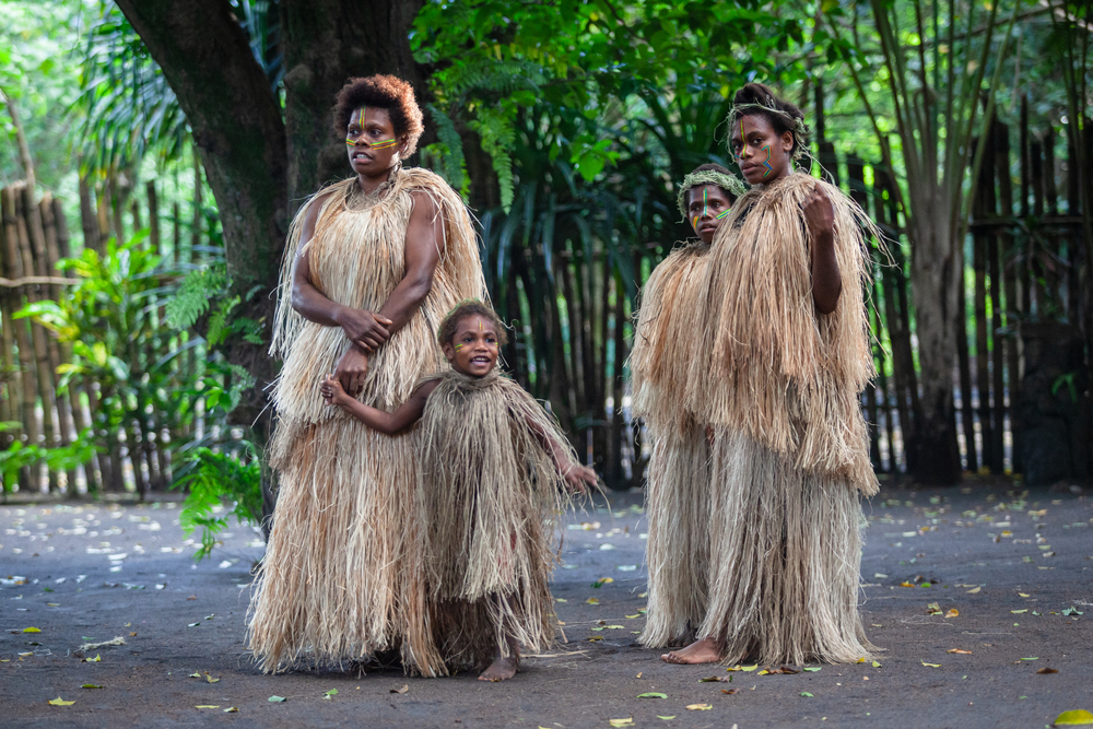 Portrait Photo of Melanesian local people in traditional indigenous straw clothes