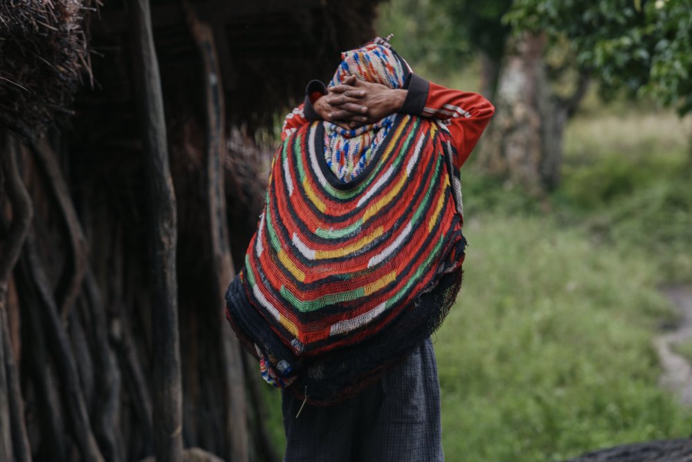 This image captures a person from Melanesia caring traditional bag called noken