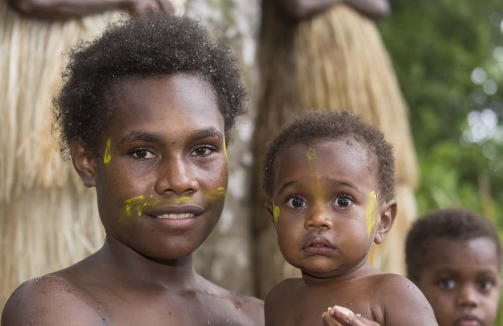 Portrait Photo of Indigenous Melanesia mother with her child in her arms