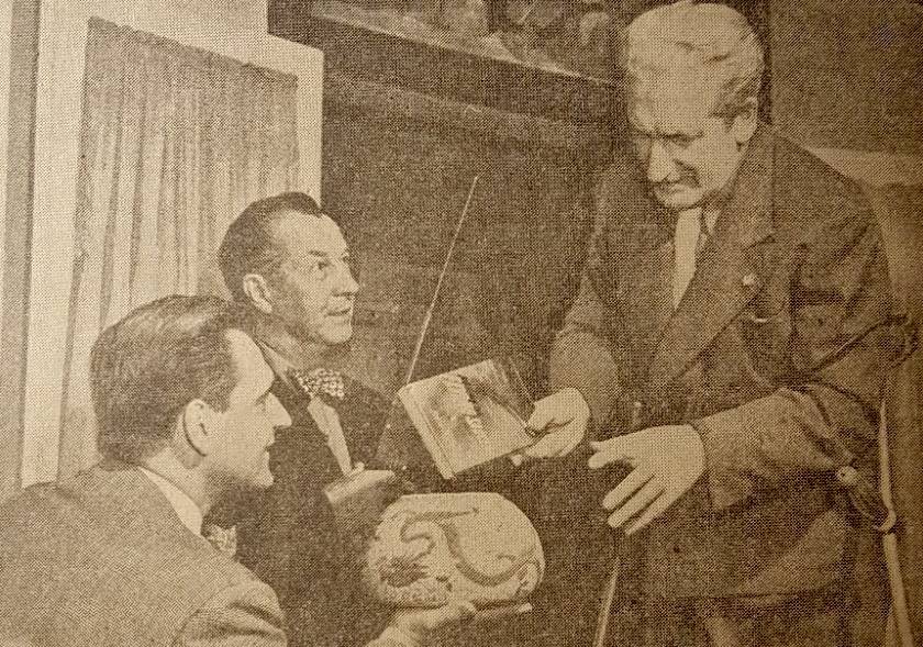 Author Frank Scully (right) and confidence man Silas Newton (center) demonstrate ideas about magnetism and earth's orbit using Scully's book Behind the Flying Saucers (1950)