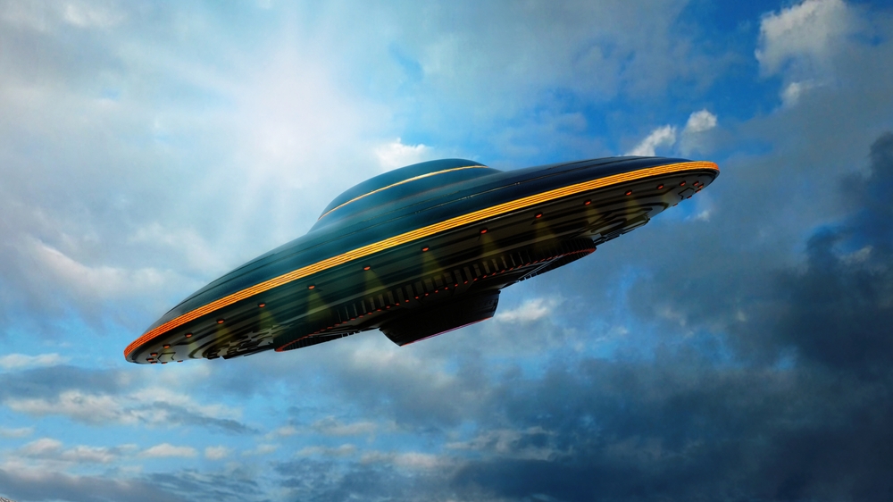 A gleaming UAP glides through the endless blue sky