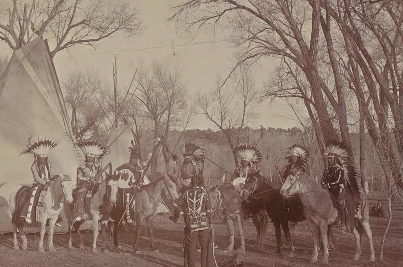Ute men in traditional dress on horseback