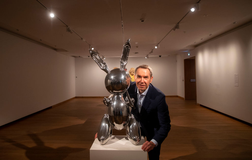 Artist Jeff Koons poses next to his piece called Rabbit during a photo call
