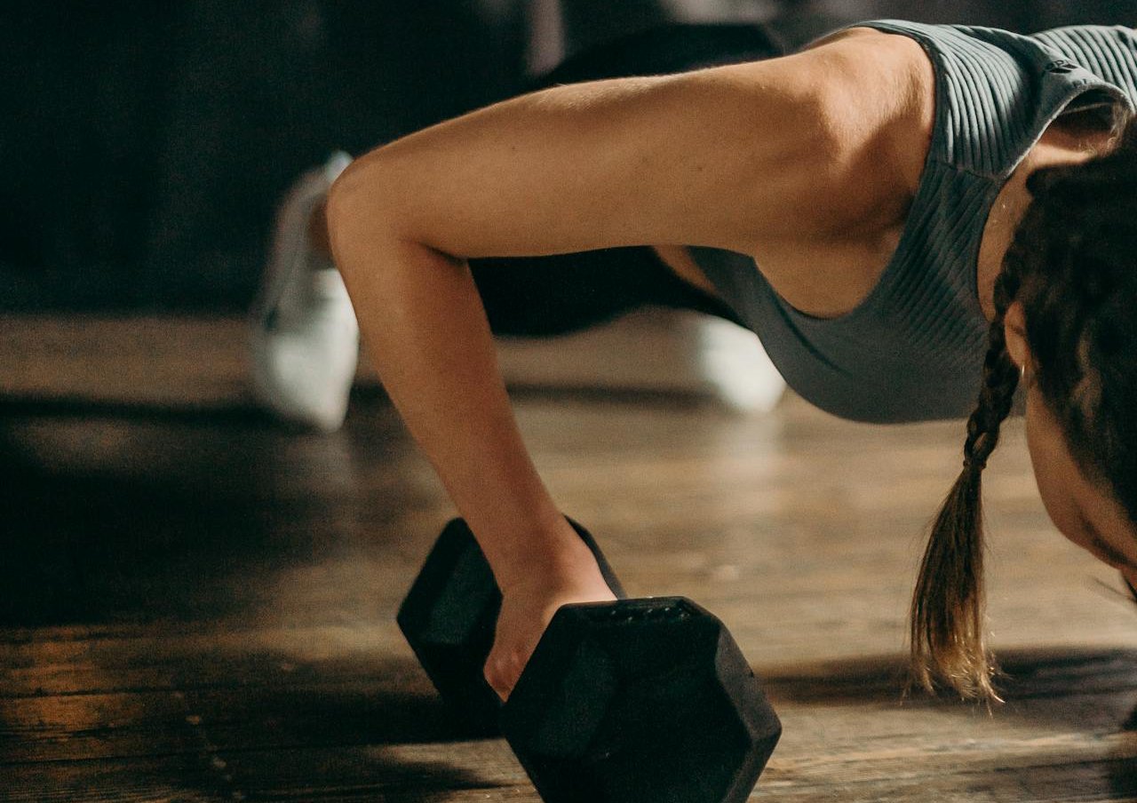 Woman in Grey Tank Top and Black Shorts Exercising