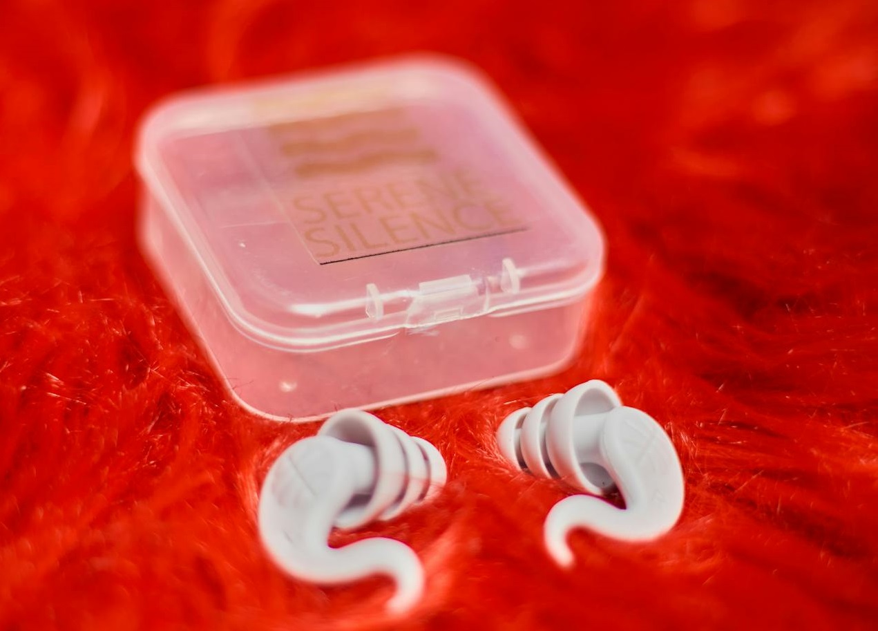 A pair of ear buds in a plastic case