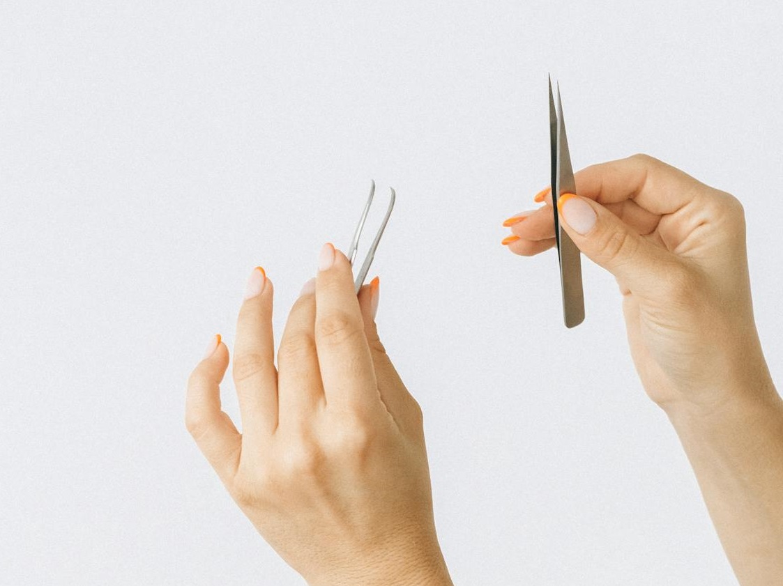 Person Holding Tweezers