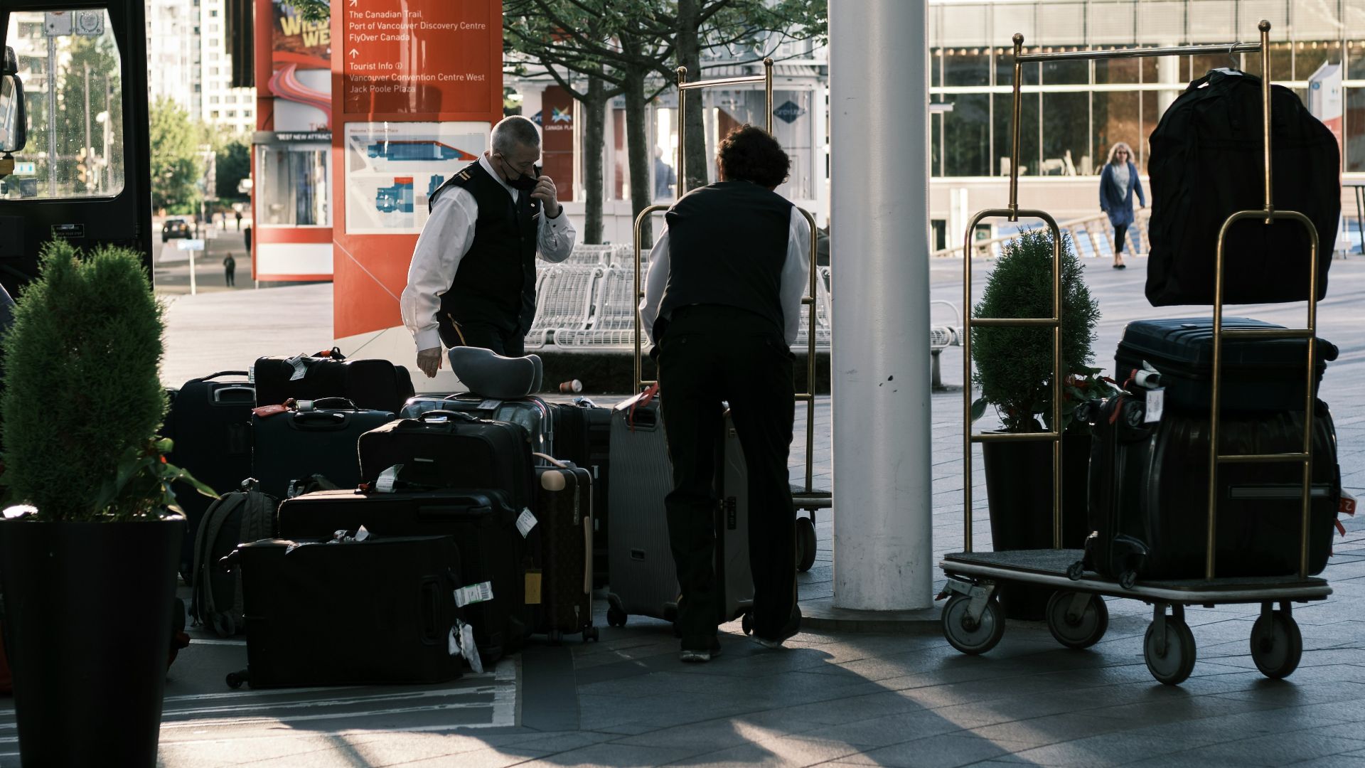 a man standing next to a pile of luggage