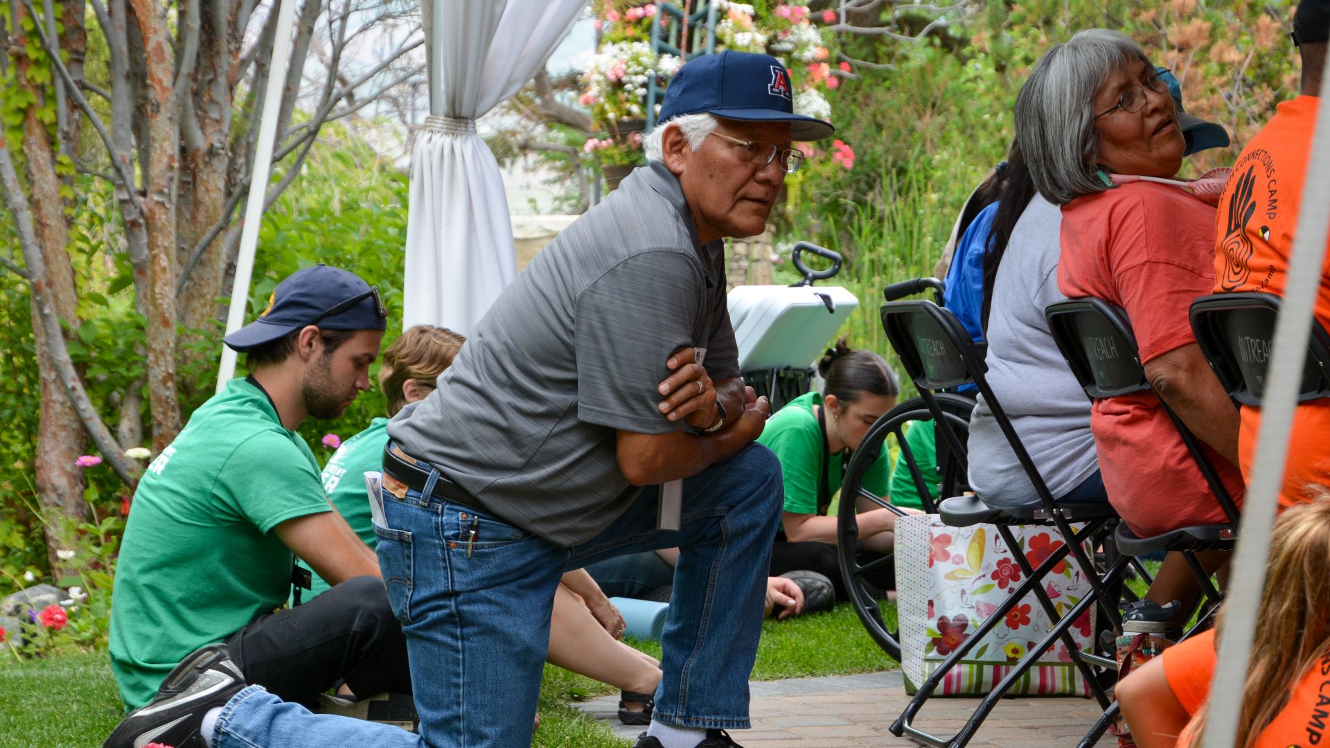 File:A person kneeling around a talking circle (53013127025).jpg