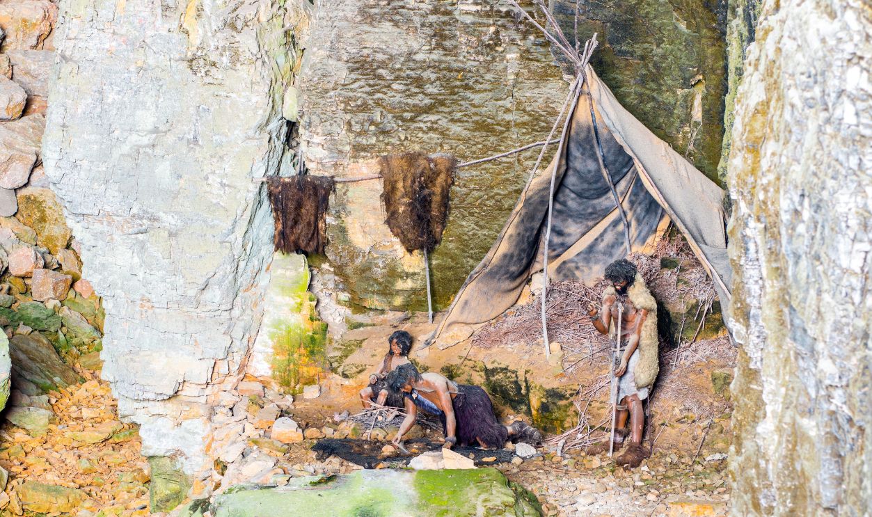 Gettyimages - 484572676, Prehistoric caveman family camp in cave of la Balme France - stock photo Horizontal photography composition of prehistoric caveman family camp in caves of la Balme in France, composed with father, mother and child. These are plastic mannequin model. Image shot in Caves of la Balme (Les Grottes de la Balme). Visited since 1807, the Caves of La Balme, located in La Balme-les-Grottes city, are one of the most outstanding natural areas in France. There are small basins (gours), draperies, stalactites and stalagmites, labyrinths, underground lake. This tourist place is located 40 km from Lyon city, in Bugey mountains, in Isere (on the border of the department of Ain), Rhone-Alpes region in France (Europe). A property release was acquired for this picture. If this fossil is real, it means our ancestors weren’t just wanderers of warm valleys but pioneers of permafrost — brave, curious, and endlessly adaptive. They didn’t just survive the cold; they claimed it.