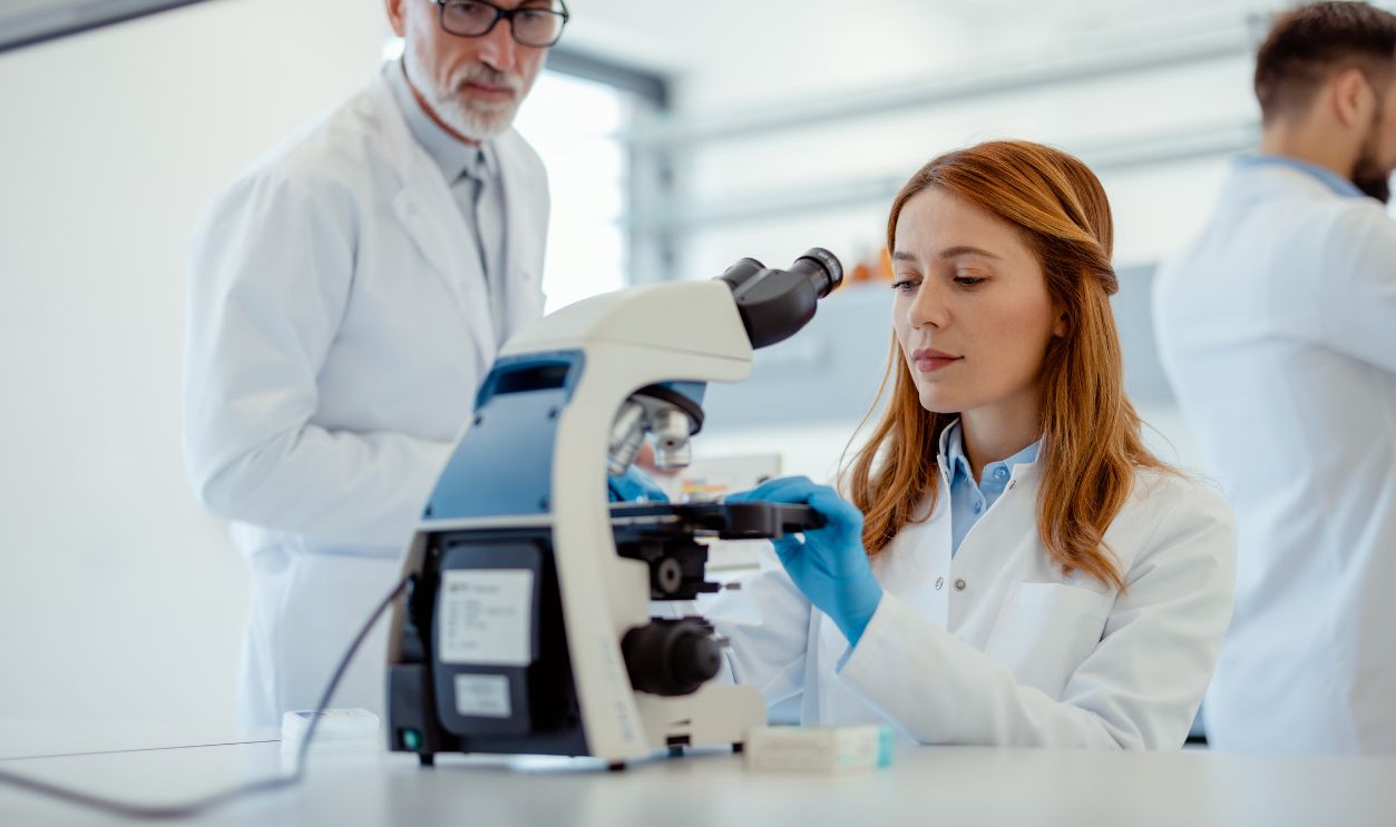 Gettyimages - 2161372285, Running diagnostics on clinical data - stock photo Medicine Development Laboratory: Biochemical Research Female Scientists Are Conducting Research in a Medical Laboratory With Her Male Scientist in the Backround