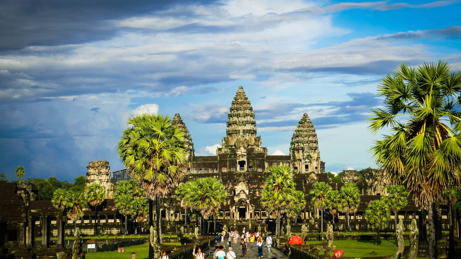 a large building with trees and people in front of it