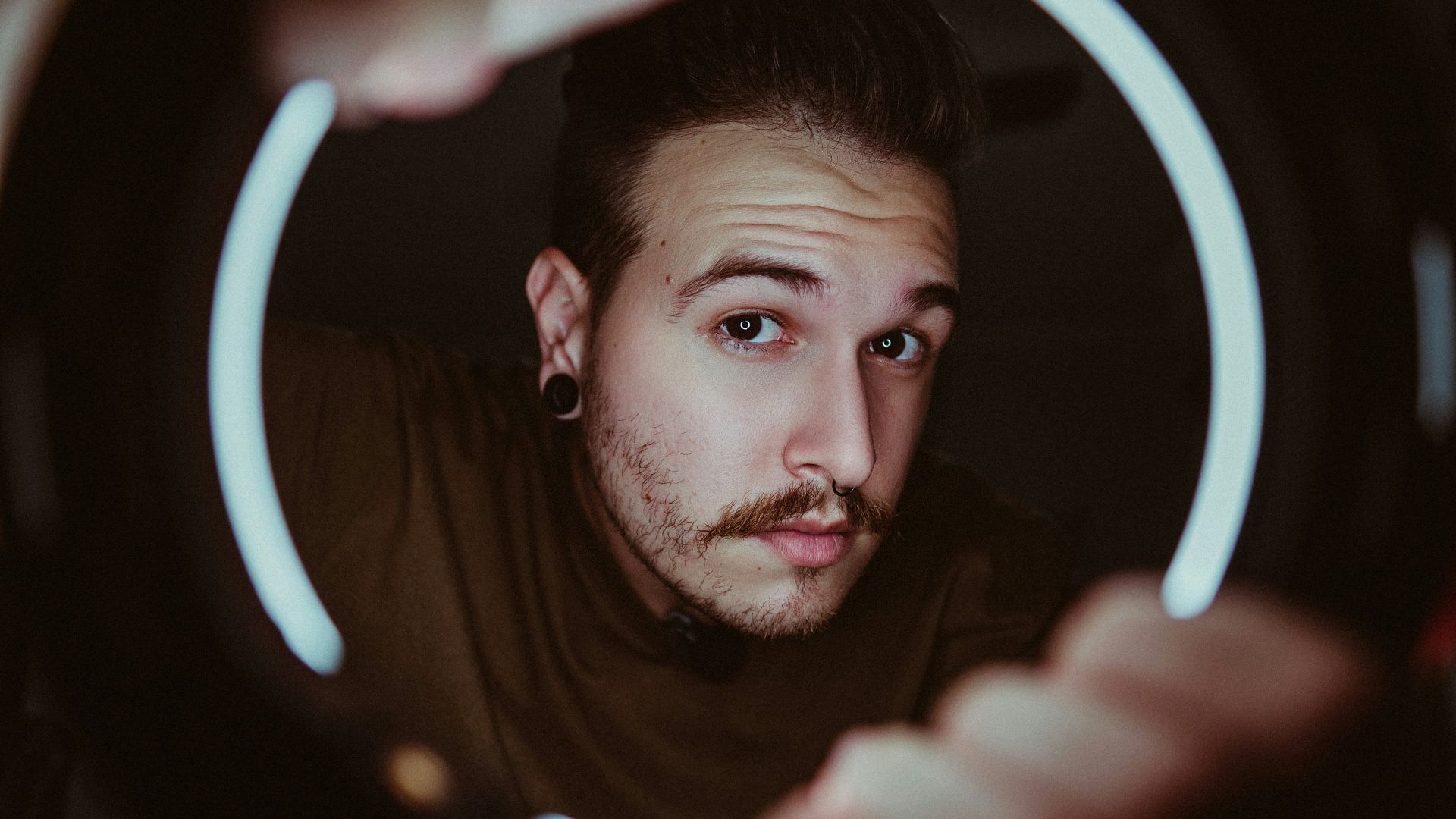 man in black shirt holding white light
