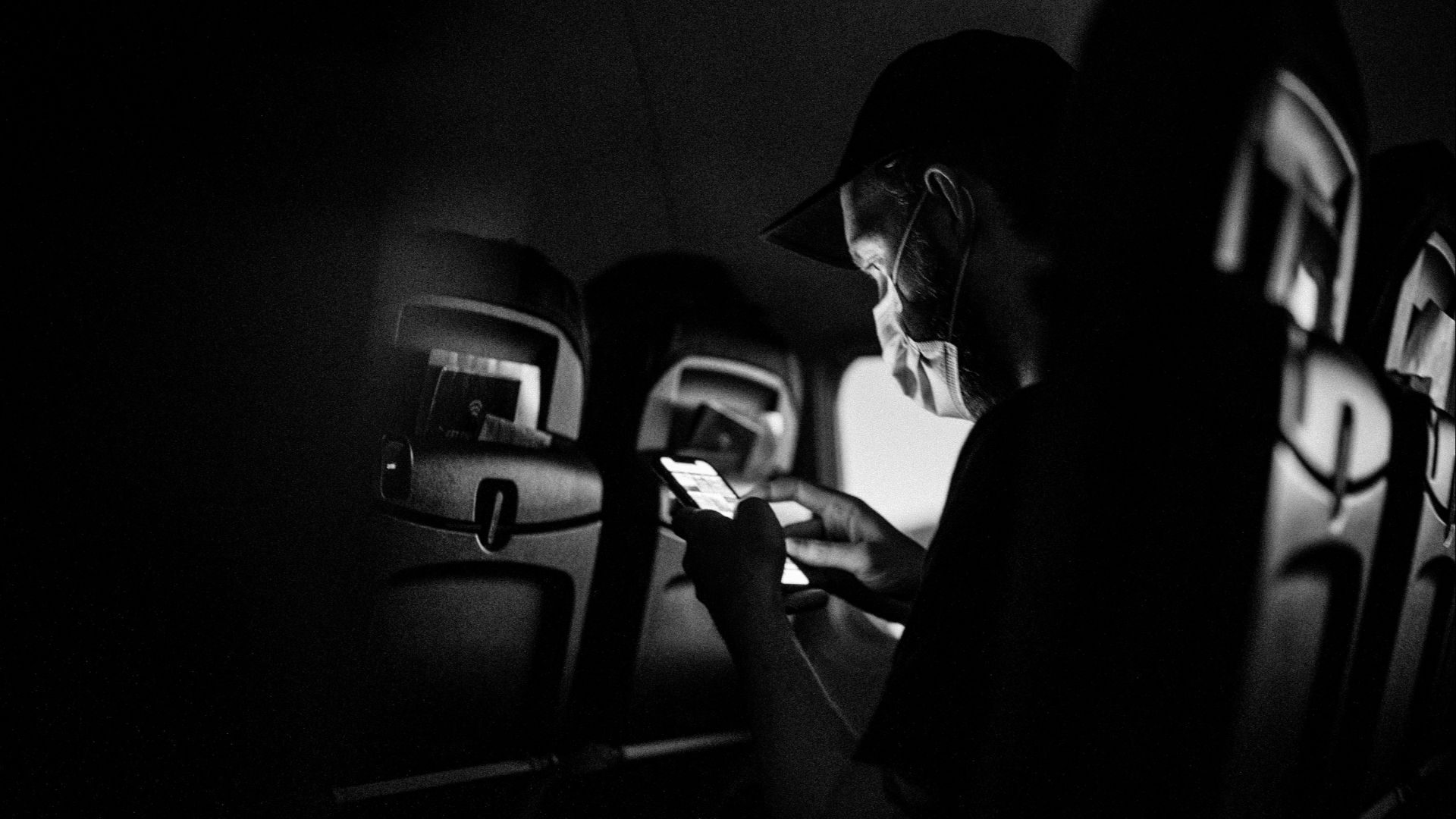 grayscale photo of man and woman kissing