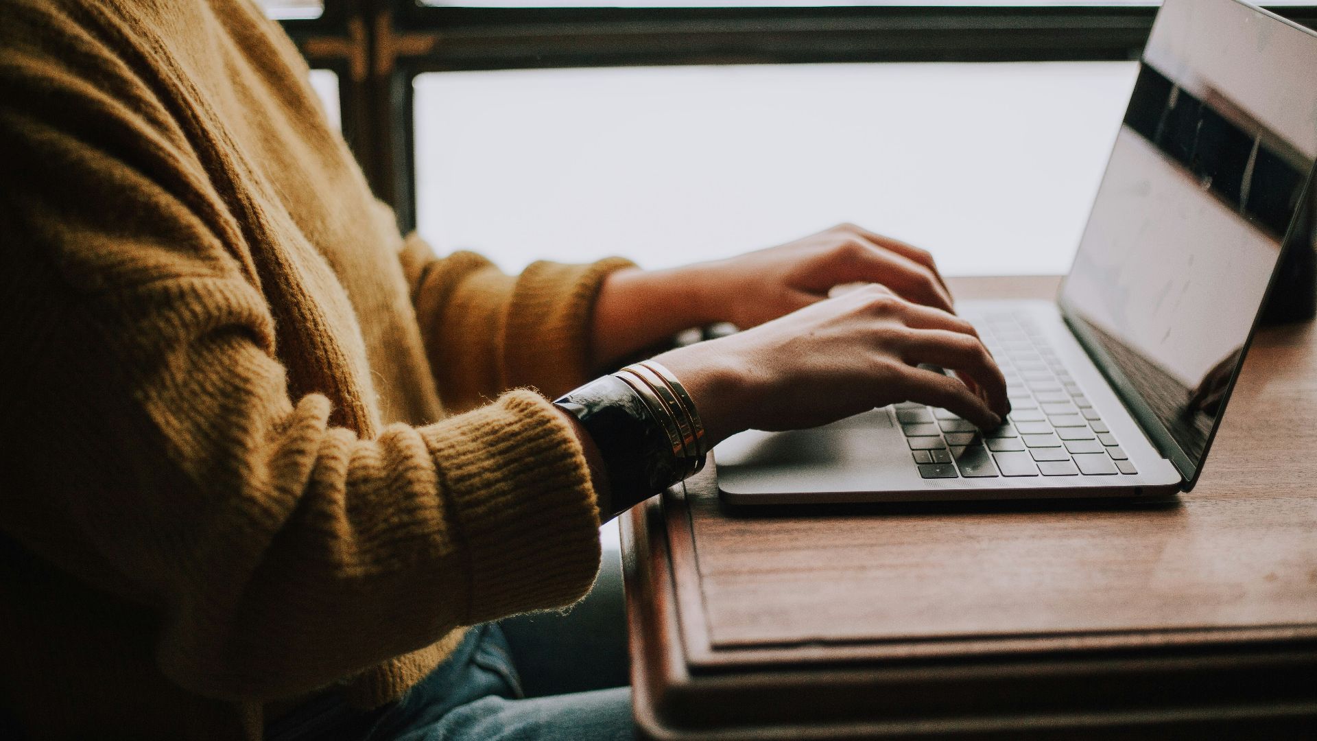 person sitting front of laptop