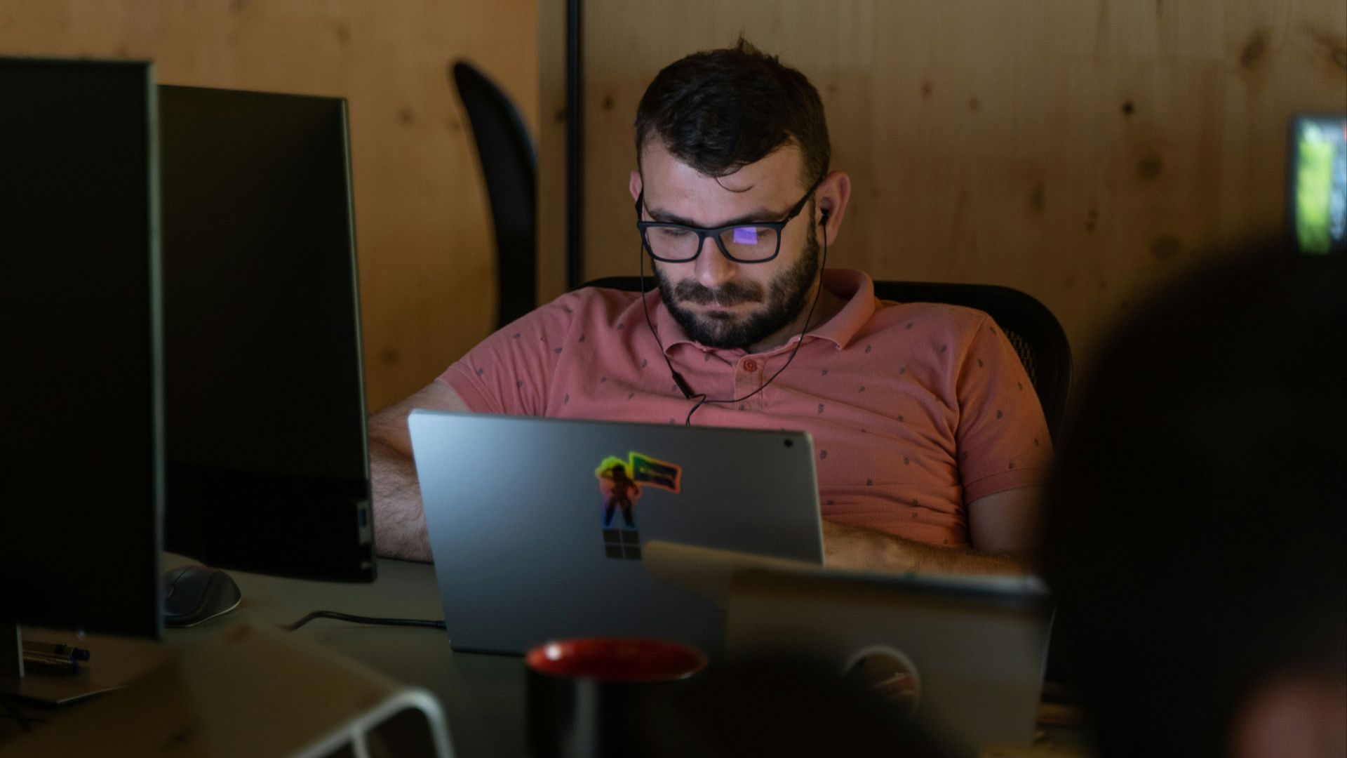 a man sitting in front of a laptop computer