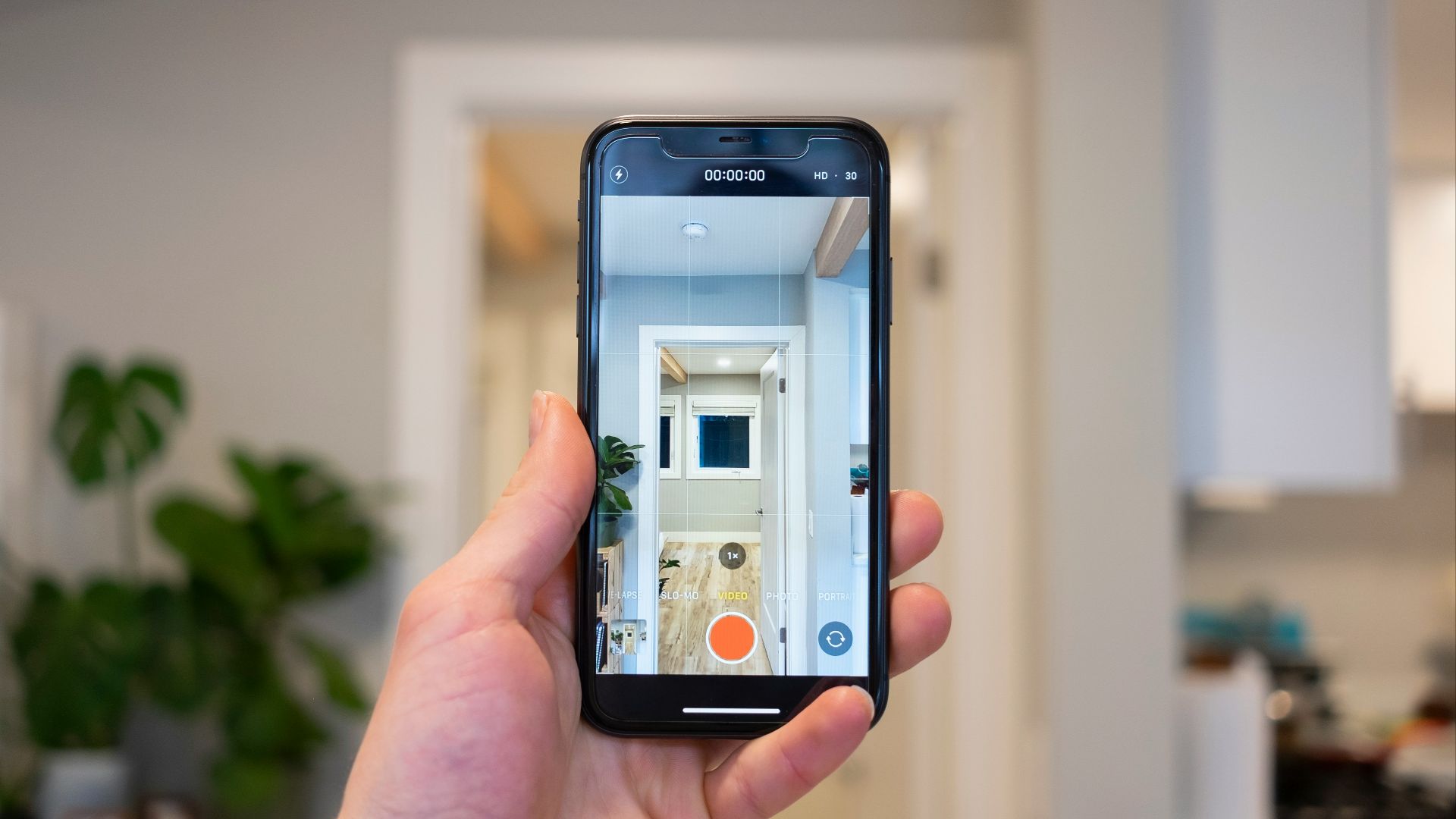 person holding silver iphone 6 taking photo of white concrete building