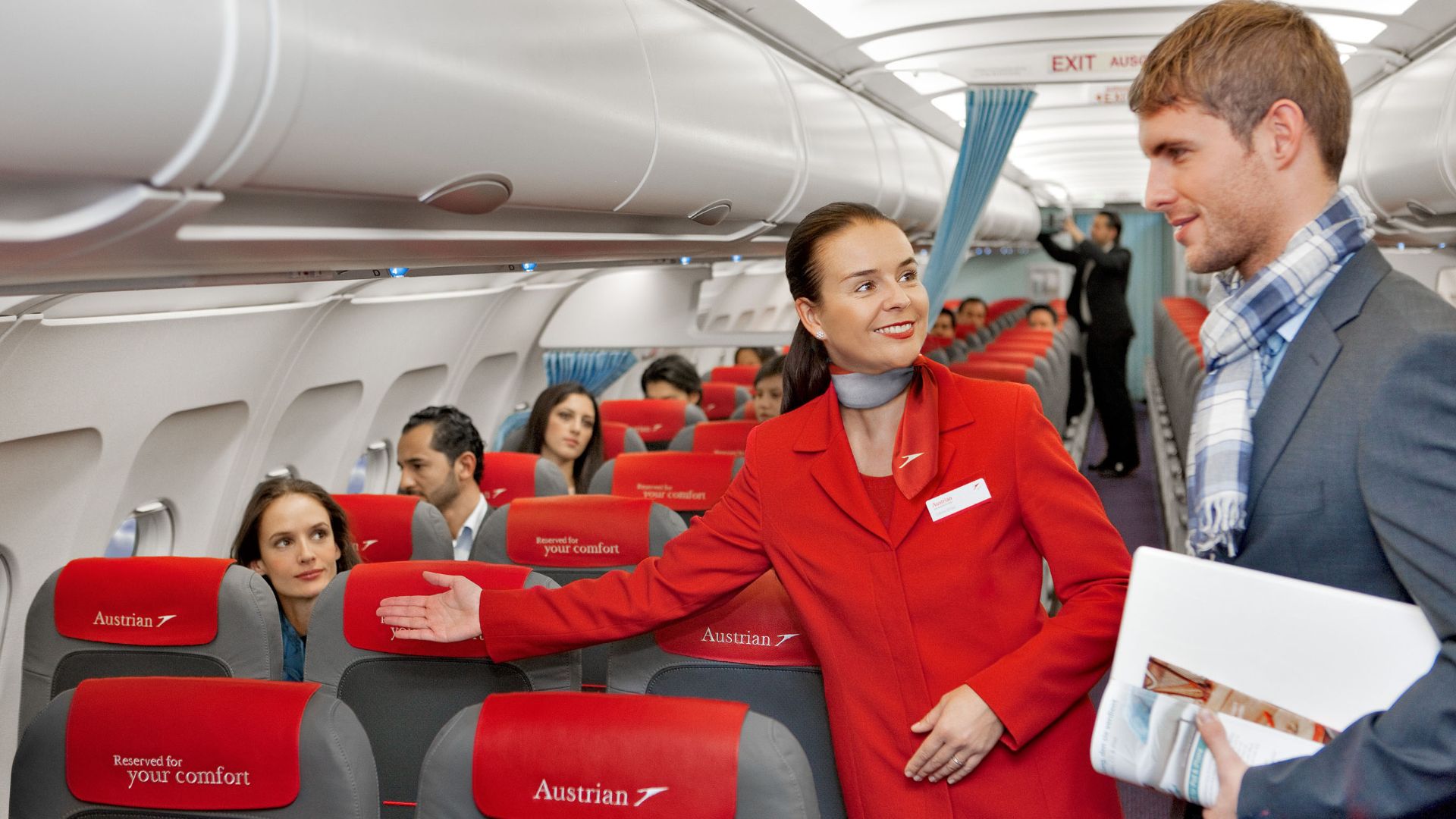 File:Austrian Airlines flight attendant and passenger.jpg