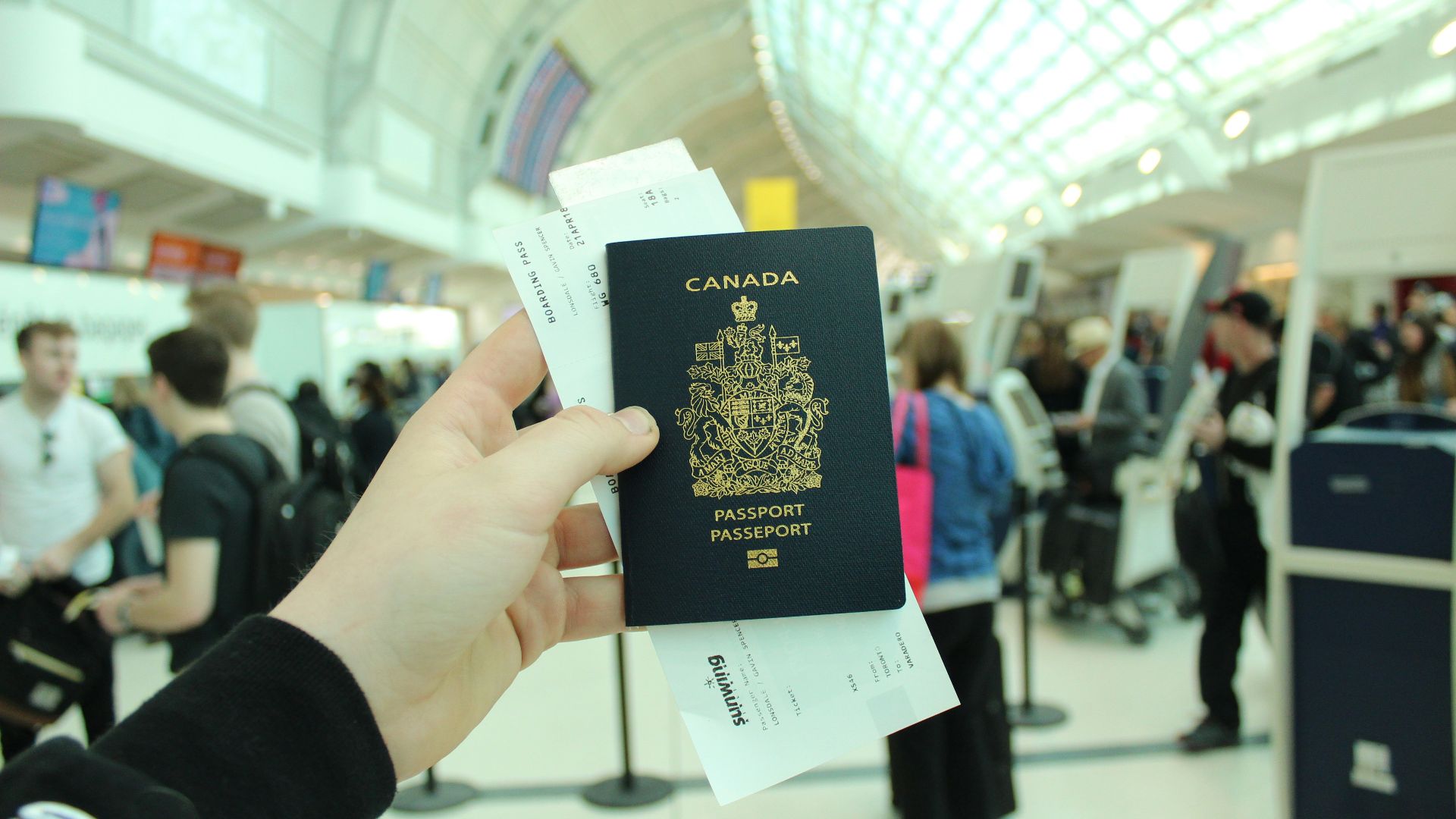 person holding Canada passport