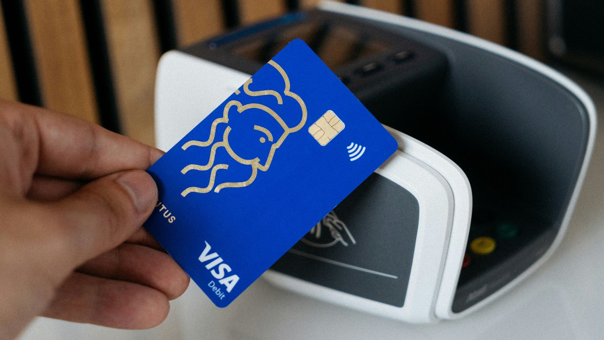 a person is holding a blue credit card