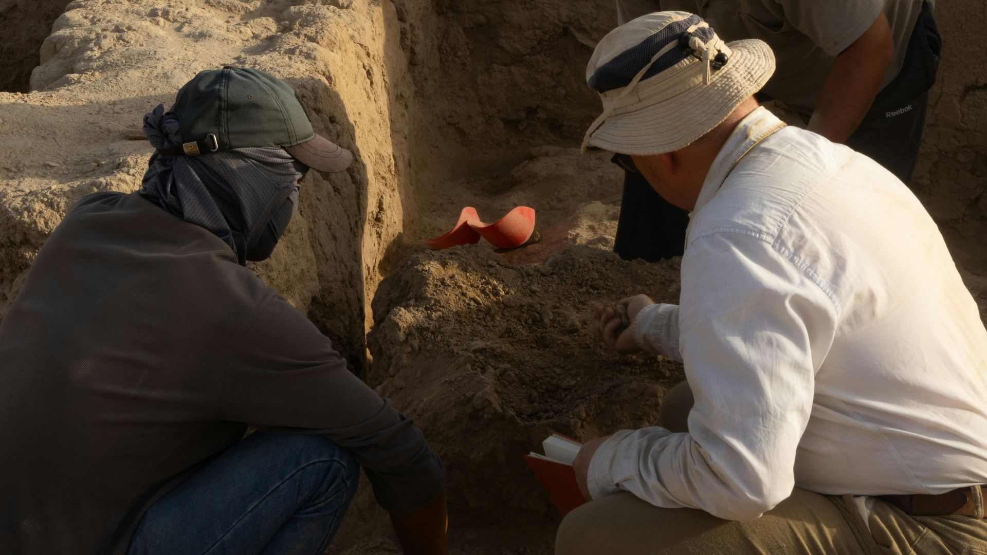 A group of men kneeling down next to each other